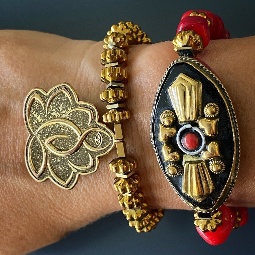 Meaningful hand model wearing Flower Of Life Bracelet - Exquisite accessory adorned with a Lotus Flower charm, Om Mani Padme Hum mantra bead, and Buddha quote message charm, handcrafted for positive energy and style.