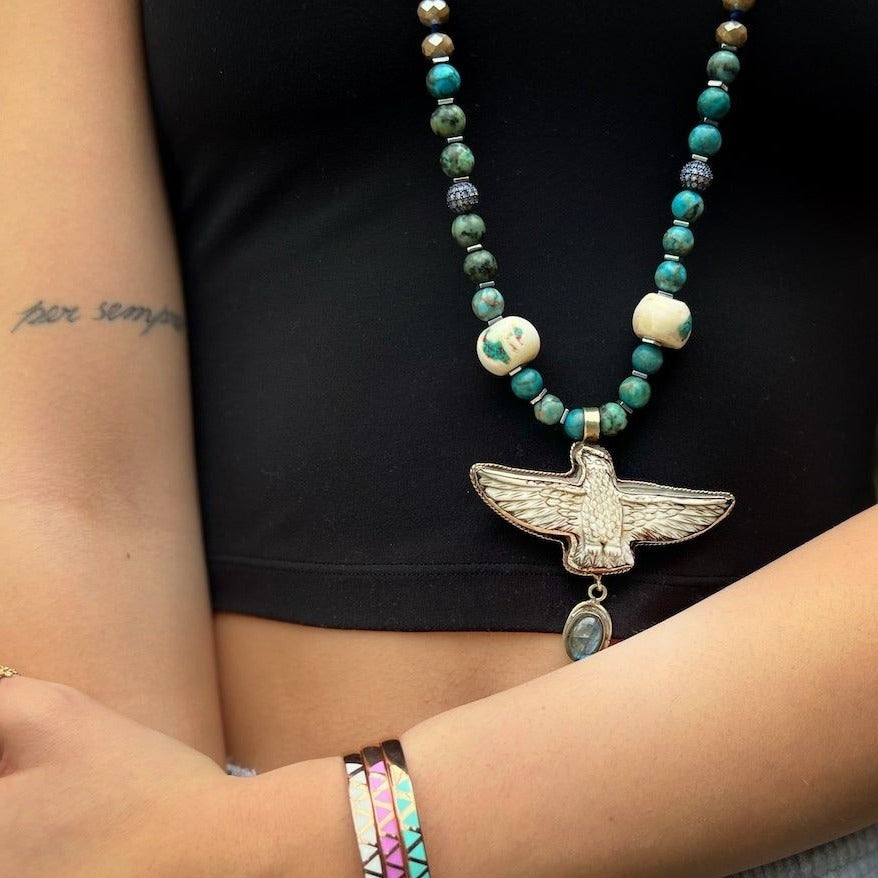 Stylish Freedom Eagle Necklace - Model wearing a handcrafted necklace with crystal beads, African turquoise, evil eye beads, and an eagle pendant, embodying strength and rebirth.