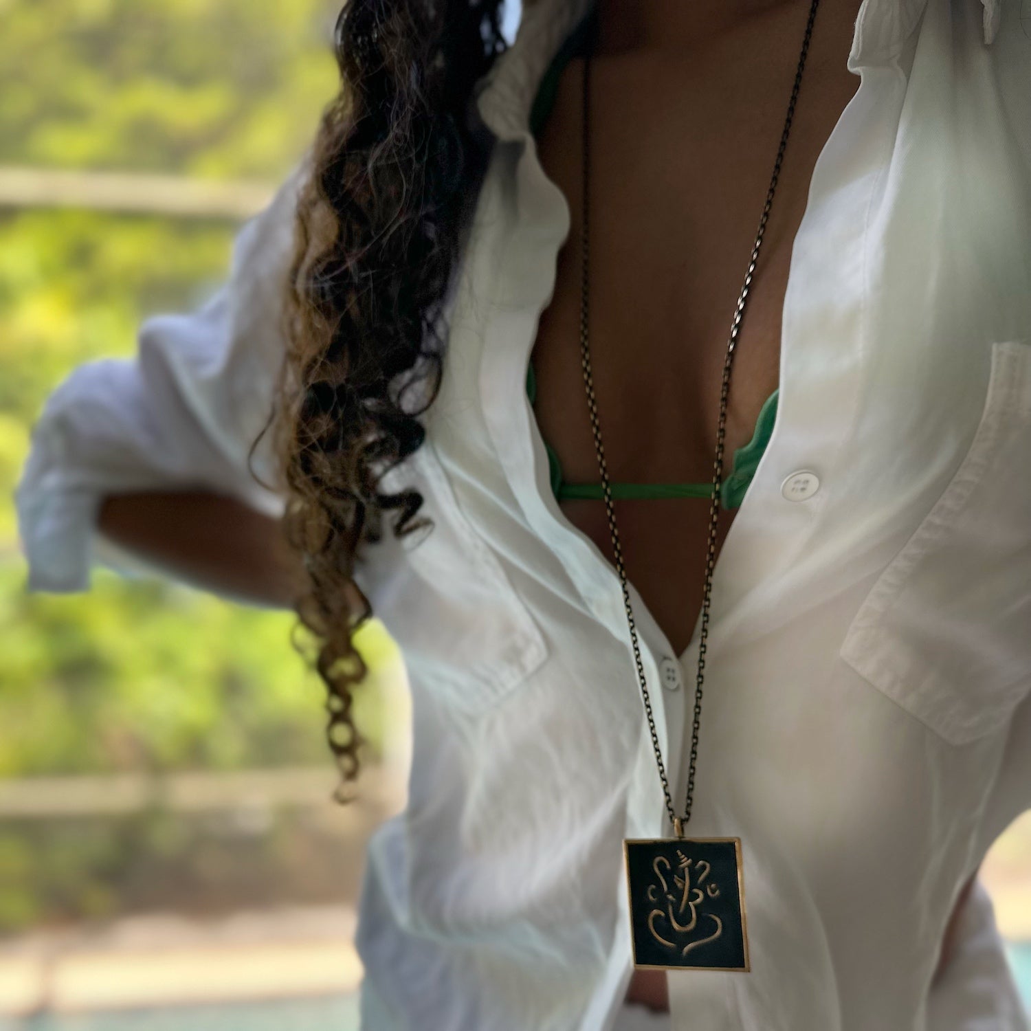 Ganesha Necklace - Model showcasing a handmade bronze pendant necklace with Ganesha, exuding spiritual significance and artistic beauty.