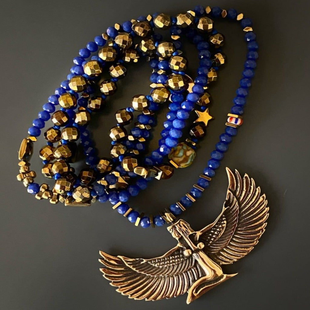Isis Symbol Necklace - Handmade accessory with a bronze pendant of the Goddess Isis, a symbol of healing and feminine power, combined with blue crystal beads and gold hematite stones for a striking and meaningful design.