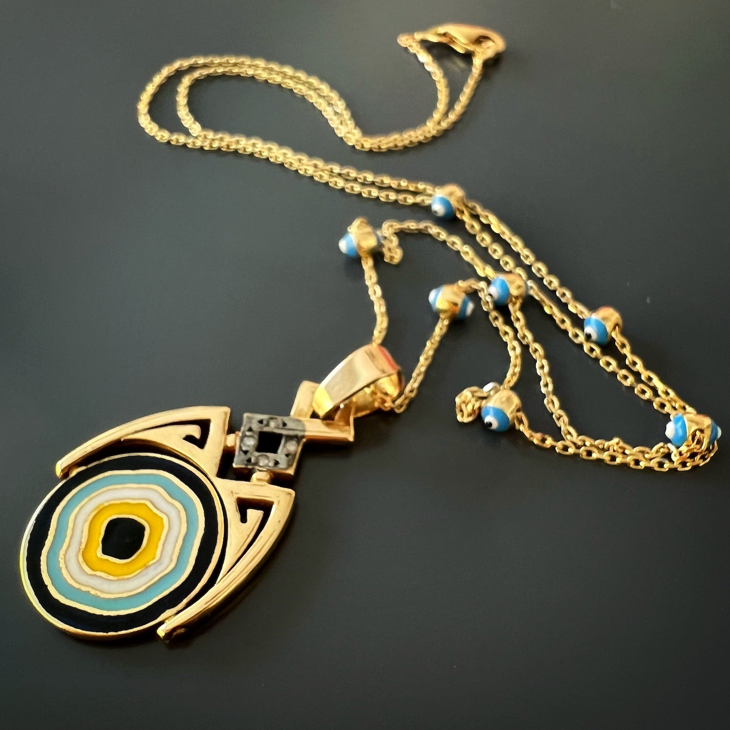 Gold and Diamond Lucky Evil Eye Necklace - A captivating necklace handcrafted from 14k yellow gold, adorned with a flip pendant featuring diamonds and intricate blue and yellow enamel.