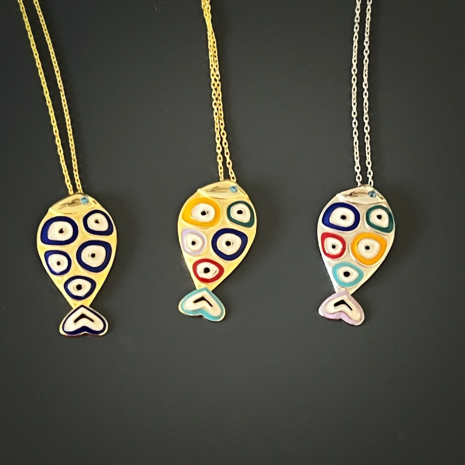 Handmade Gold and Enamel Fish Pendant Necklace - Exquisite necklace made with care from 925 Sterling silver on 18K gold plated chain, showcasing a fish pendant with intricate evil eye designs and vibrant enamel.