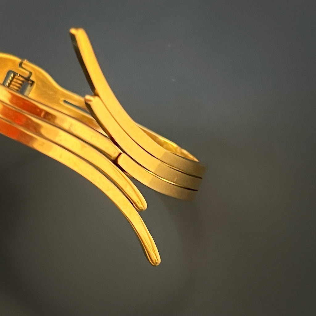 Modern Gold Bangle Bracelet - An image capturing the modern and versatile nature of the gold bangle bracelet. Its adjustable size makes it suitable for different wrist sizes, while its 18K gold plated steel construction adds a touch of luxury.