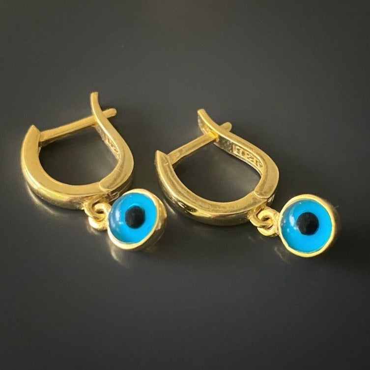 Enamel Evil Eye Huggie Hoop Earrings - A captivating image showcasing the stunning enamel evil eye charm on the Gold Huggie Hoop Earrings.