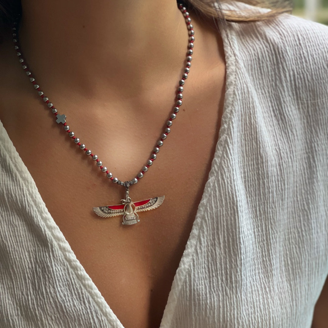 Stylish model showcasing the handcrafted Faravahar necklace with red hand knot