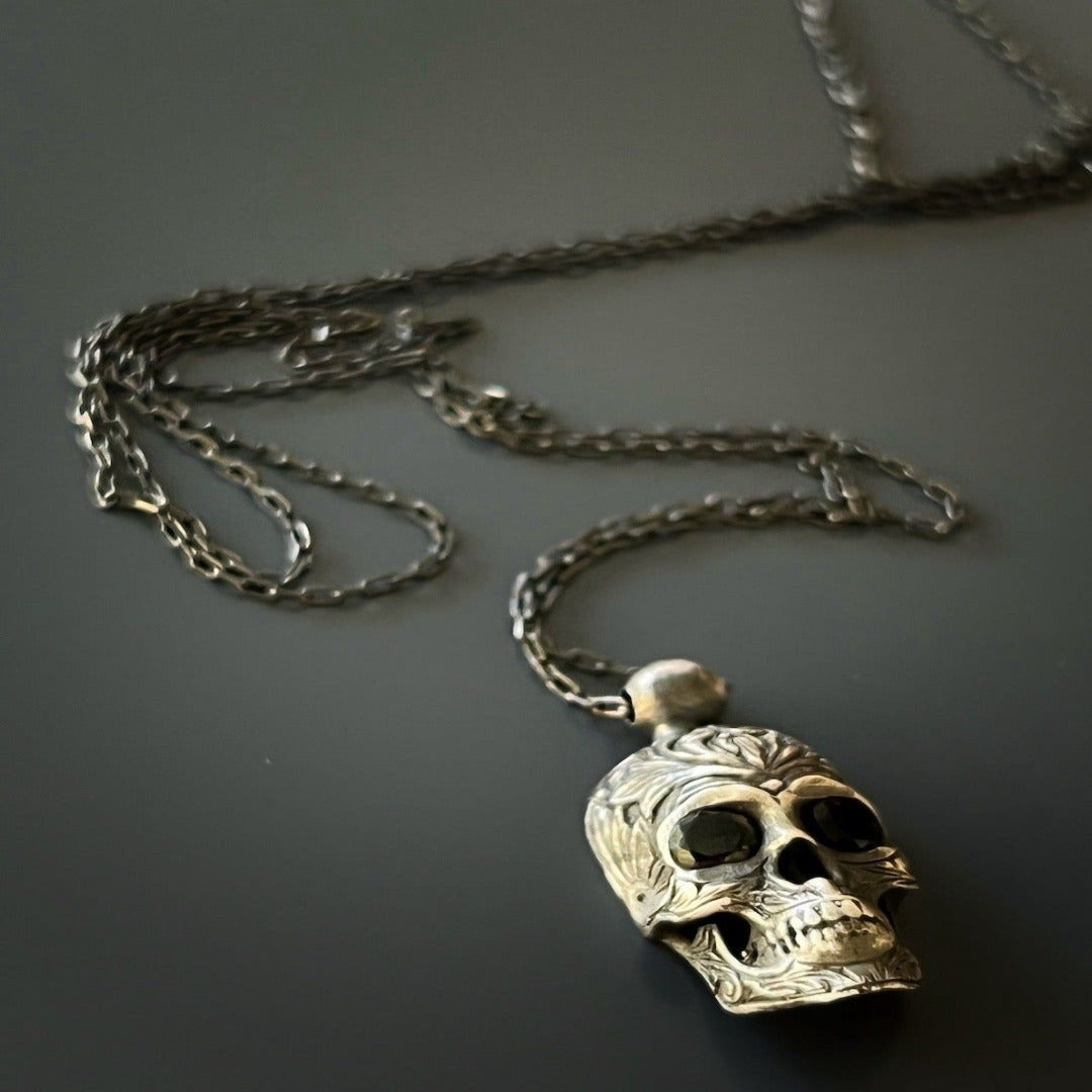Unique handmade necklace featuring a sterling silver skull pendant with captivating Swarovski crystal accents