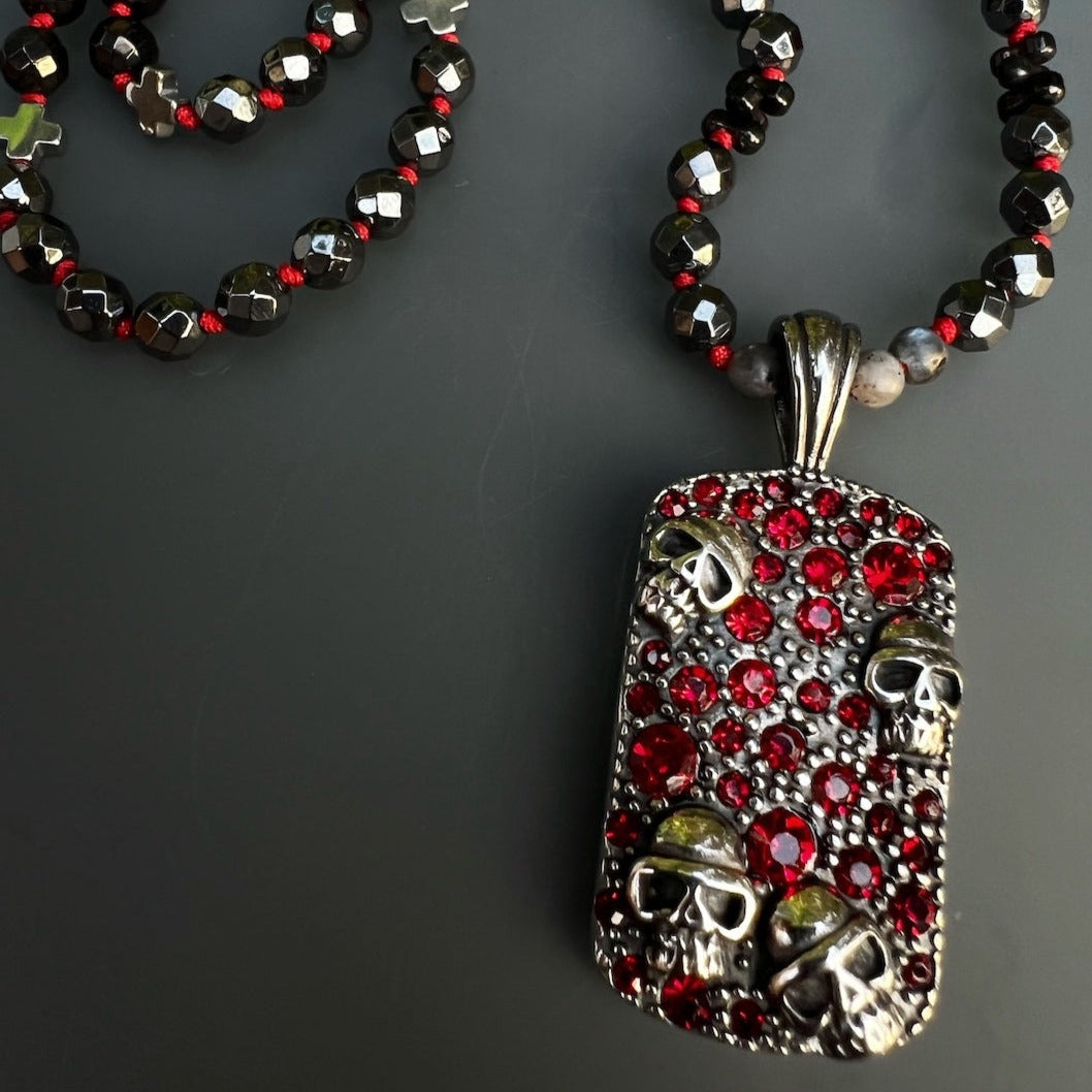 Gothic Red Skull Necklace featuring black faceted hematite beads and a striking stainless steel skull pendant