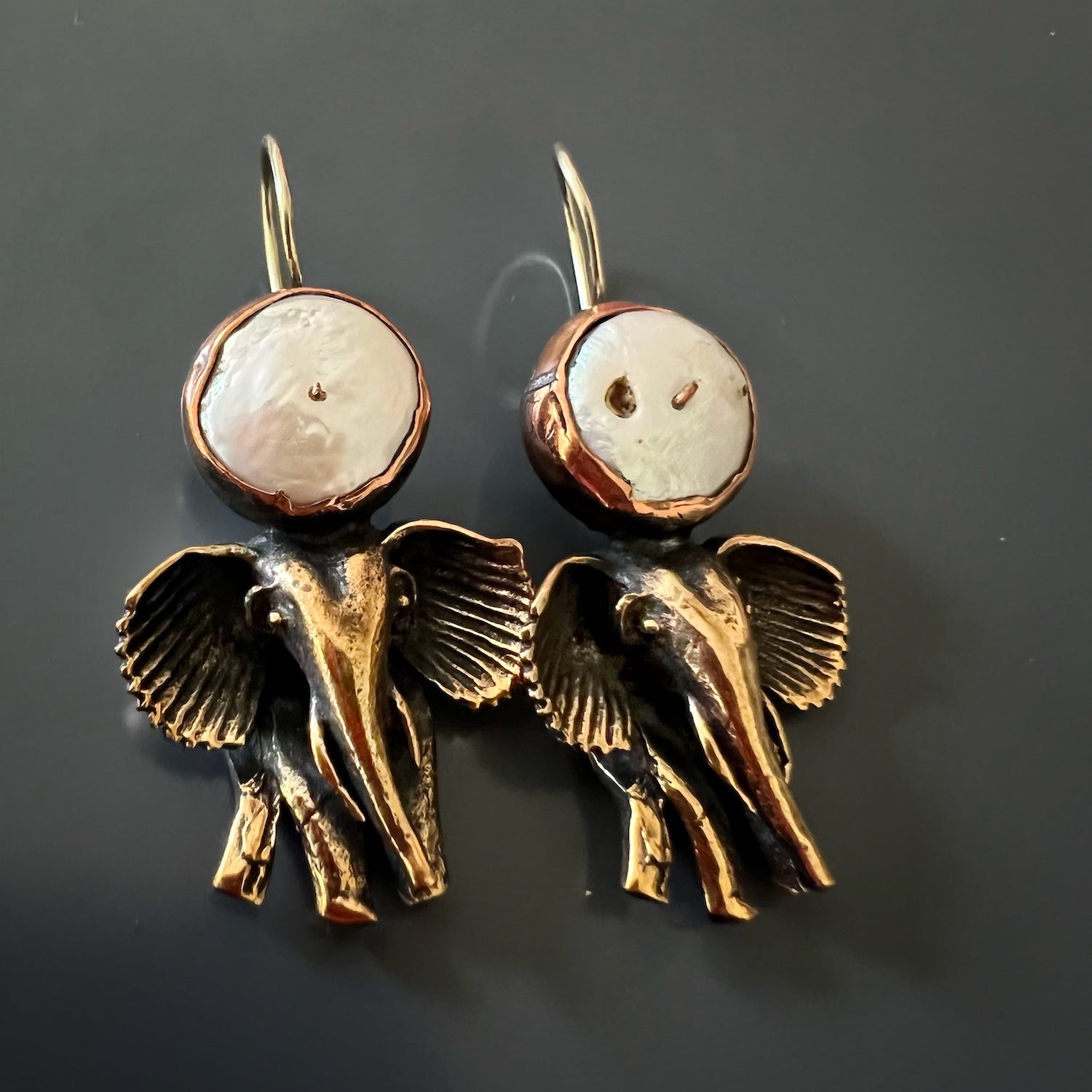 Top-down view of the Handmade Unique Spirit Elephant Earrings, displaying the whimsical and sophisticated elephant design with its intricate details and the beautiful pearl gemstone embellishment.