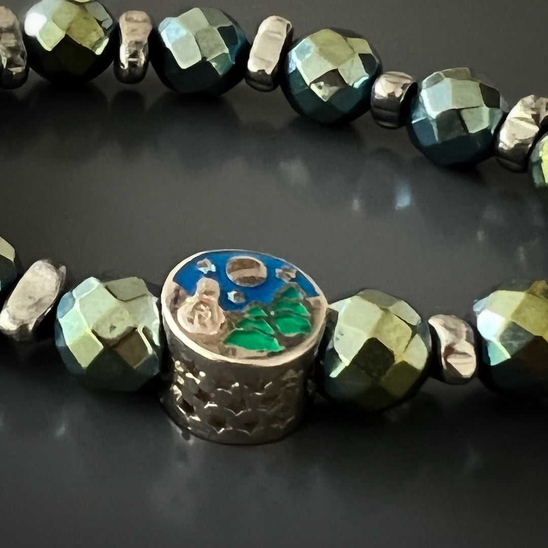 Embrace the protective properties of the Hematite Energy Bracelet, adorned with green faceted Hematite stone beads and a Sterling silver star charm.
