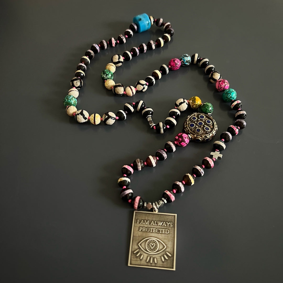 Discover the power of protection with the I Am Always Protected Necklace, adorned with colorful jasper beads and a silver Evil Eye pendant.
