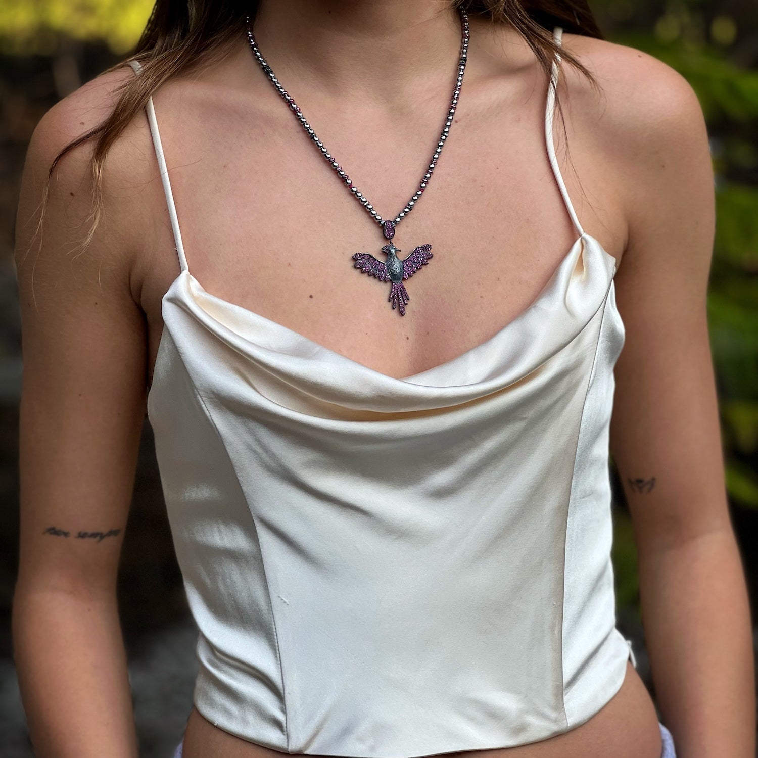 A model wearing the Inner Rebirth Phoenix Necklace, a symbol of strength and new beginnings.