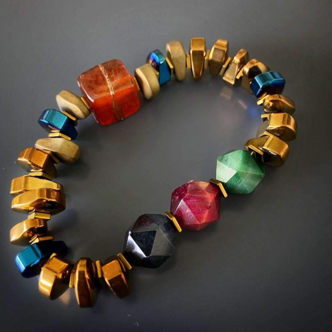 A stunning display of the Karma Hematite Bracelet, highlighting the unique colors and textures of the jasper stone and the complementing gold and blue hematite beads.