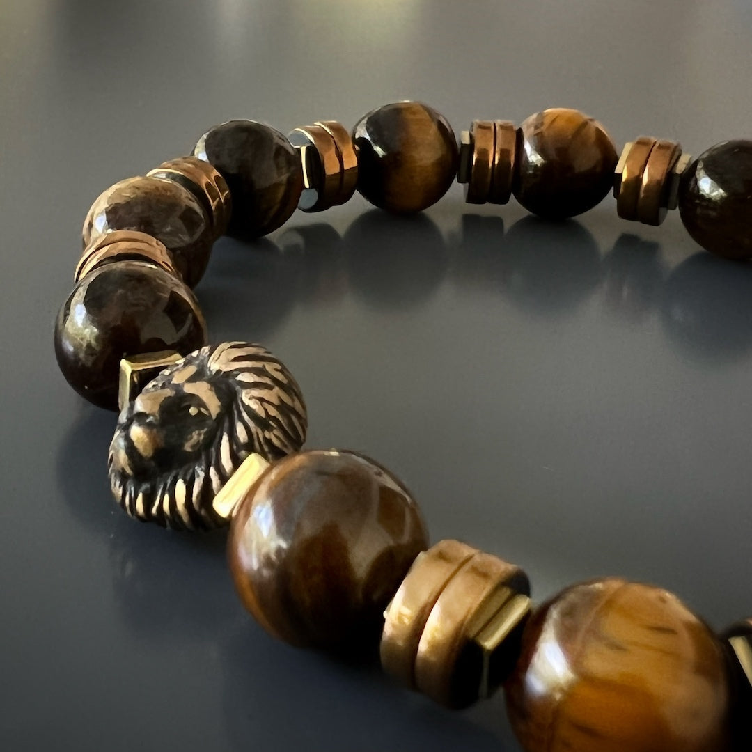 The Lion Men Bracelet, a symbol of courage and power, adorned with Tiger&#39;s eye stone beads and a bronze lion charm.