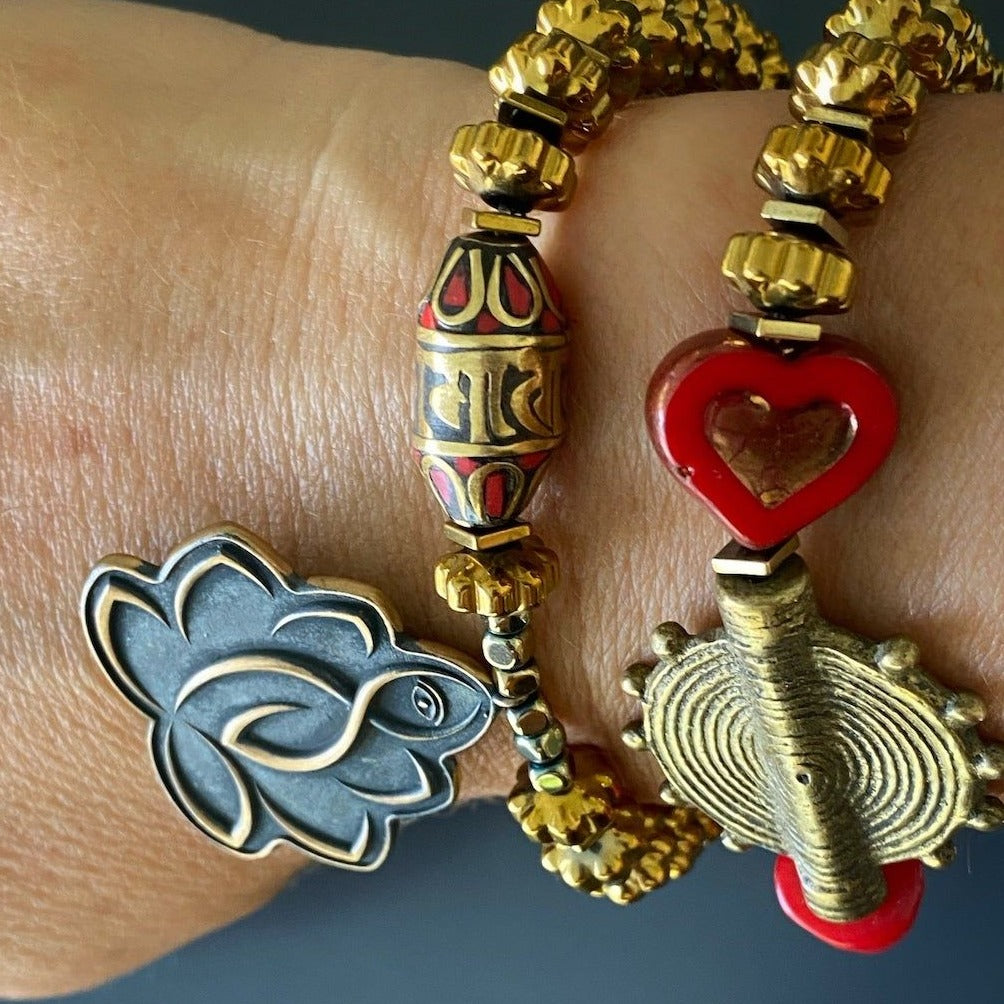 Enhance your spiritual journey with the Lotus Flower Mantra Bracelet, showcased by a hand model, featuring a mantra bead and a captivating Poker Dice Bead.