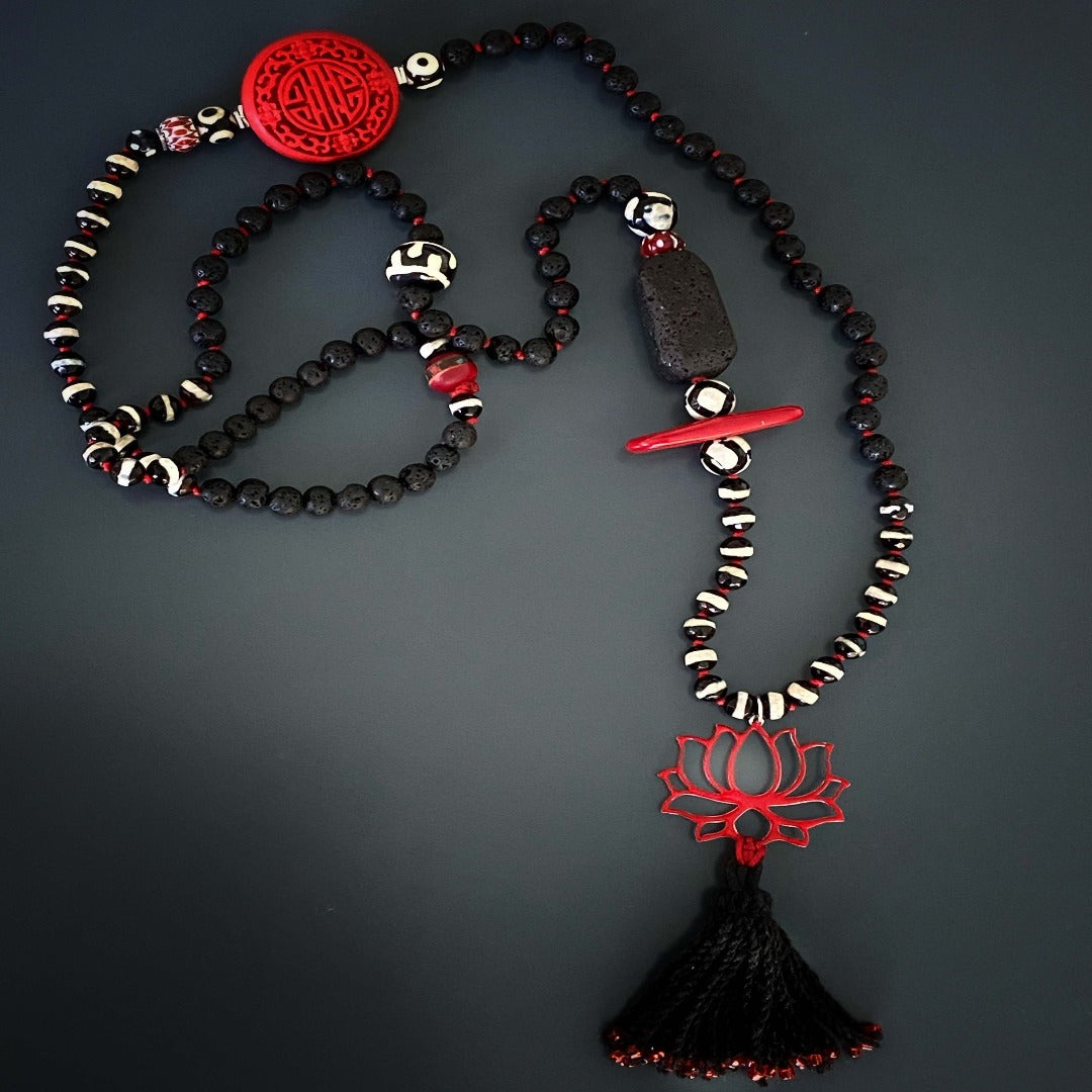 Embrace the unique design of the Lotus Flower Necklace, accentuated by African beads and tribal Tibetan beads.