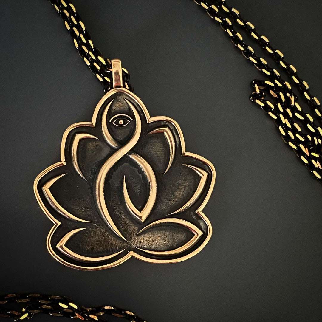 Experience the elegance of the Lotus Flower Protective Hope Necklace, adorned with a gold-plated lotus pendant and evil eye symbols.