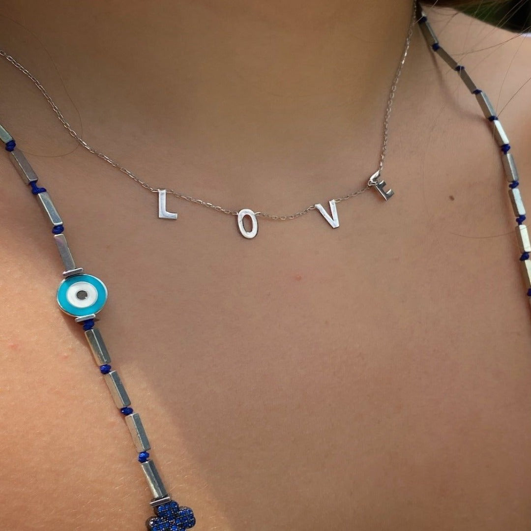 Adorn your neck with the Love Necklace, just like our model, and feel the love and beauty that radiates from this stunning piece of jewelry.