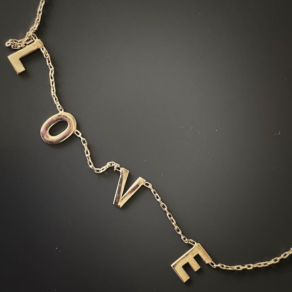 Experience the versatility of the Love Necklace, available in both sterling silver and 18K gold plating, perfect for any style or occasion.
