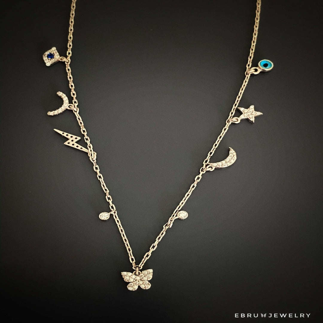 Embrace the significance of the Lucky Symbols Necklace, featuring a range of lucky symbols, including evil eye, moon, butterfly, thunder, star, and rainbow, beautifully crafted with 925 sterling silver.