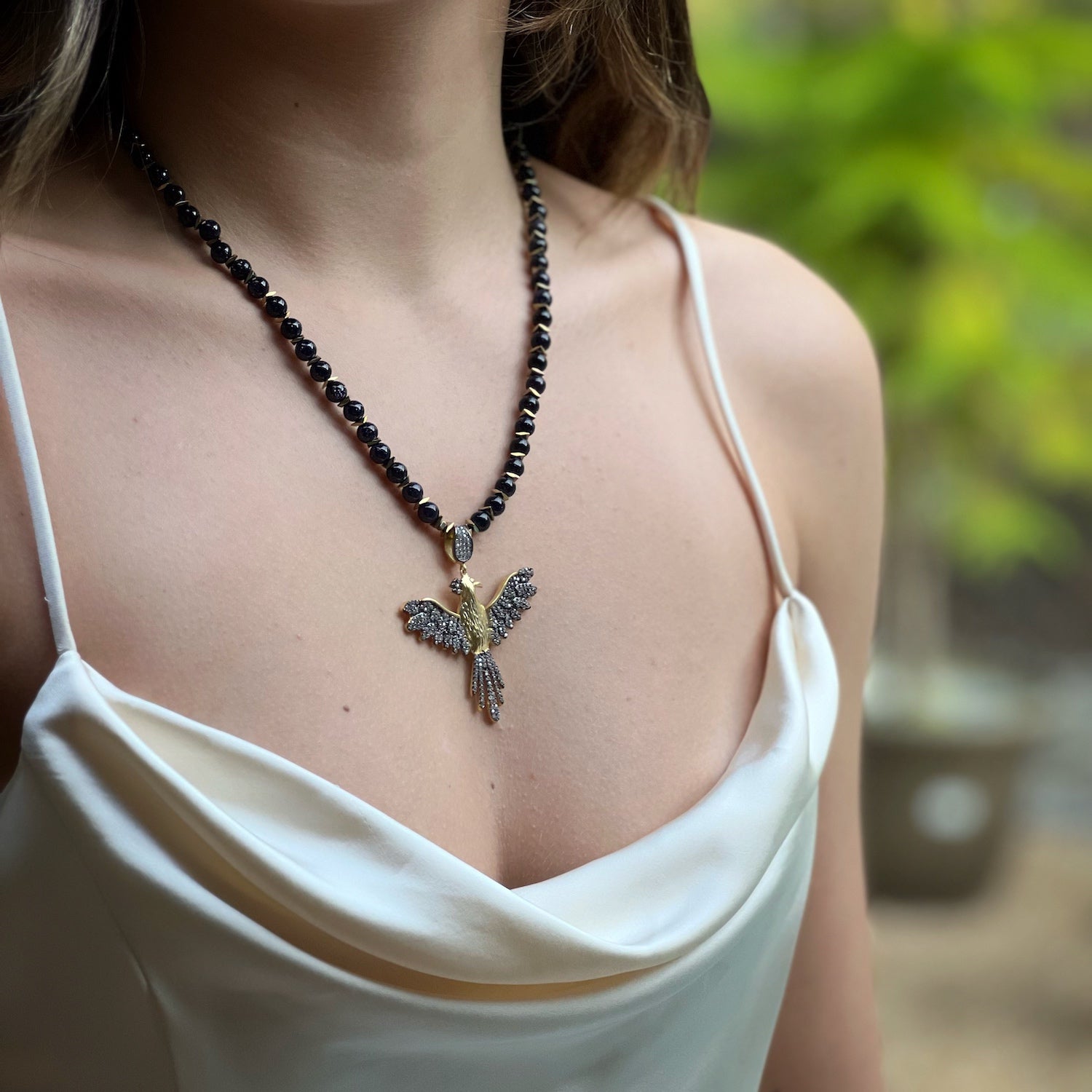 The model showcases the captivating beauty of the Magical Phoenix Bird Necklace, embodying the spirit of rebirth and transformation.