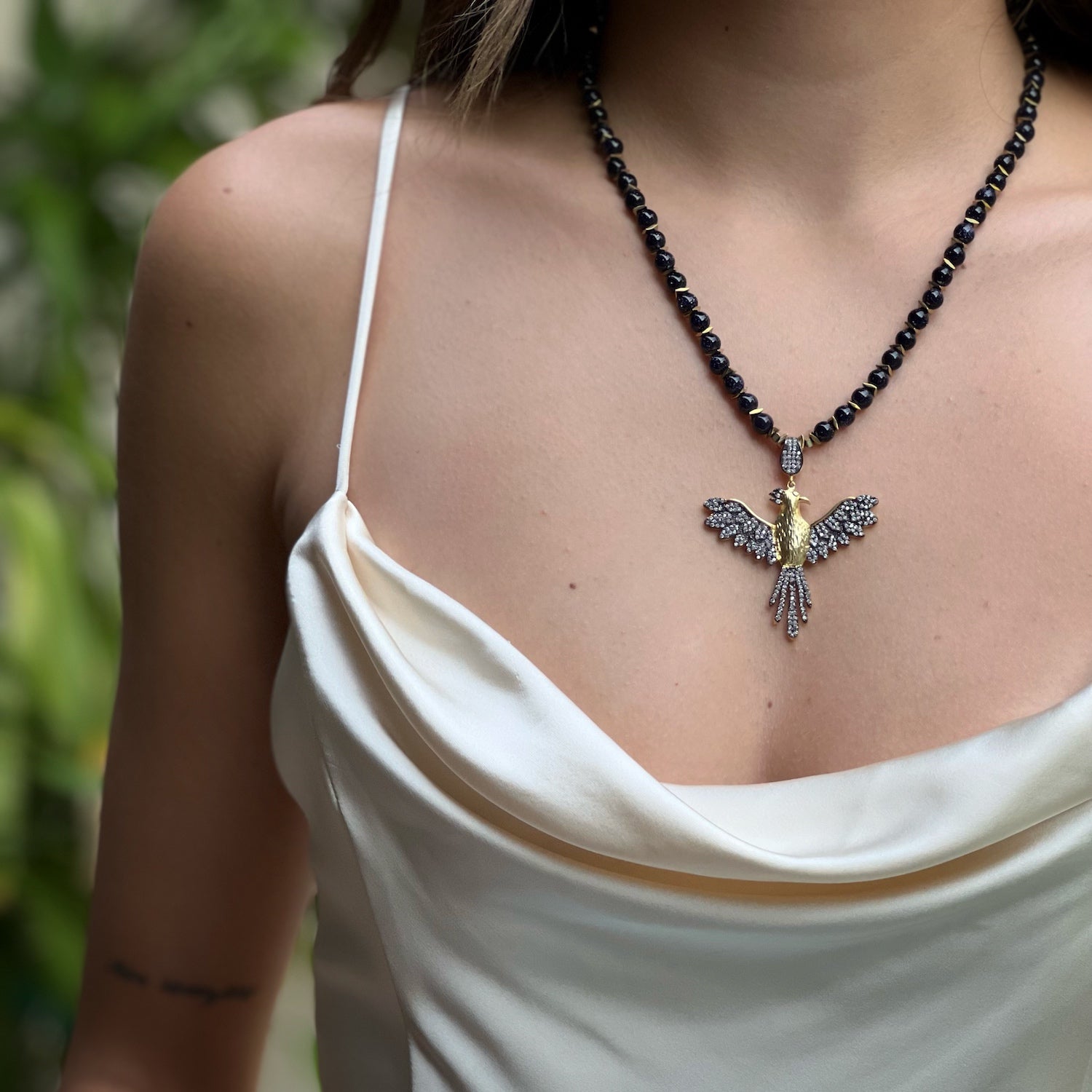 Model wearing the Magical Phoenix Bird Necklace, exuding confidence and grace with this stunning piece.