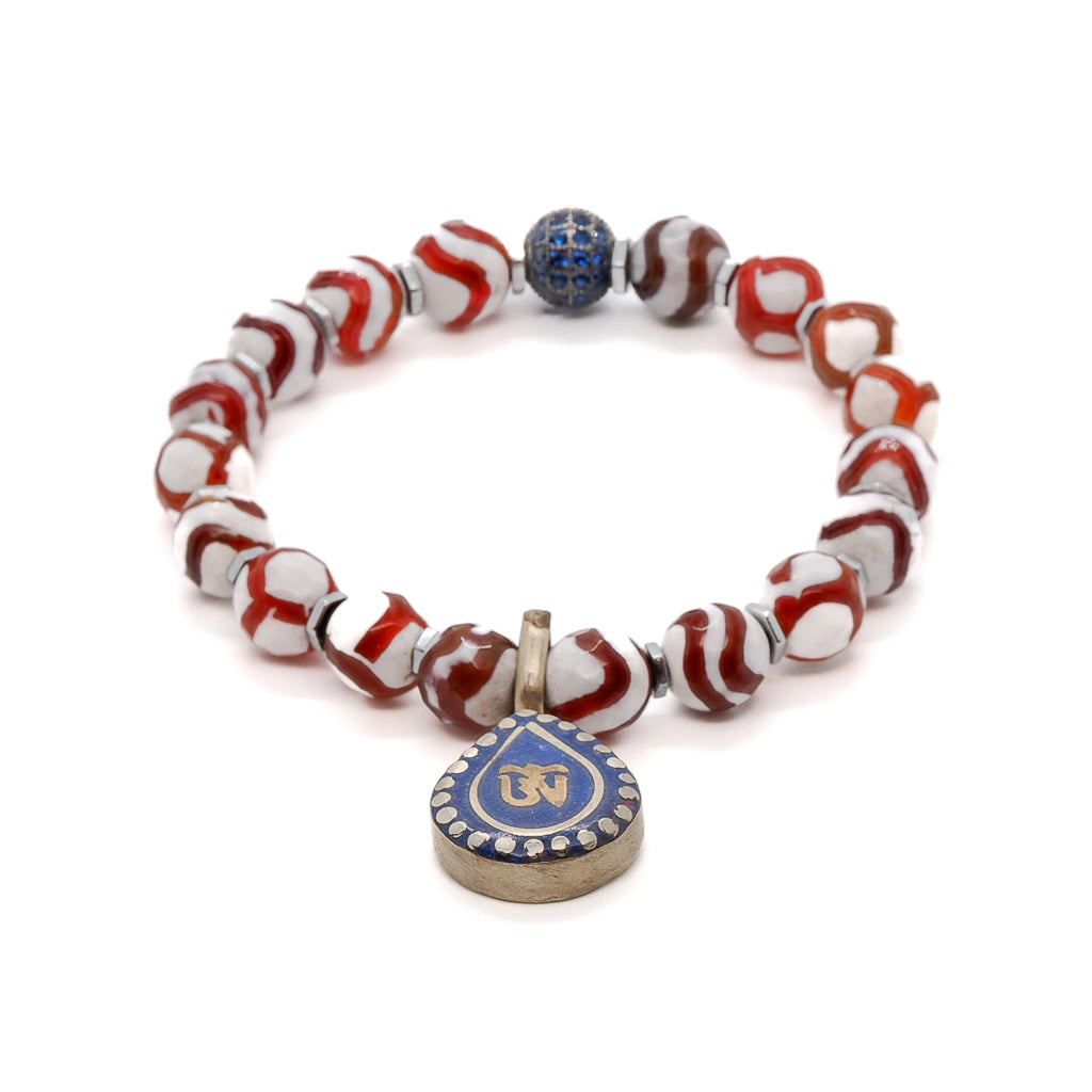 Discover the spiritual beauty of the Maya Bracelet, featuring Nepal Agate, Hematite spacers, and a handmade Om Mantra charm with Lapis Lazuli inlay.