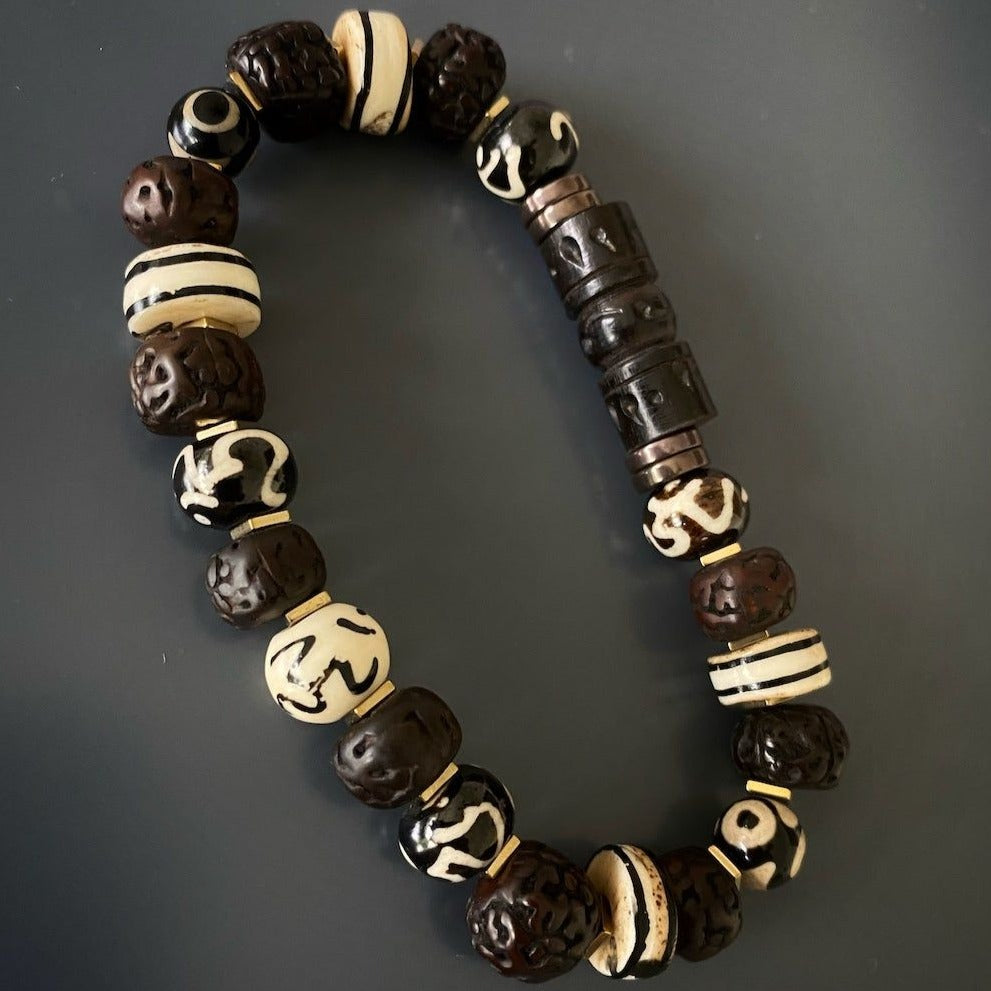 Discover the spiritual essence of the Meditation Yoga Bracelet, adorned with intricately carved Om Nepal yak bone beads.