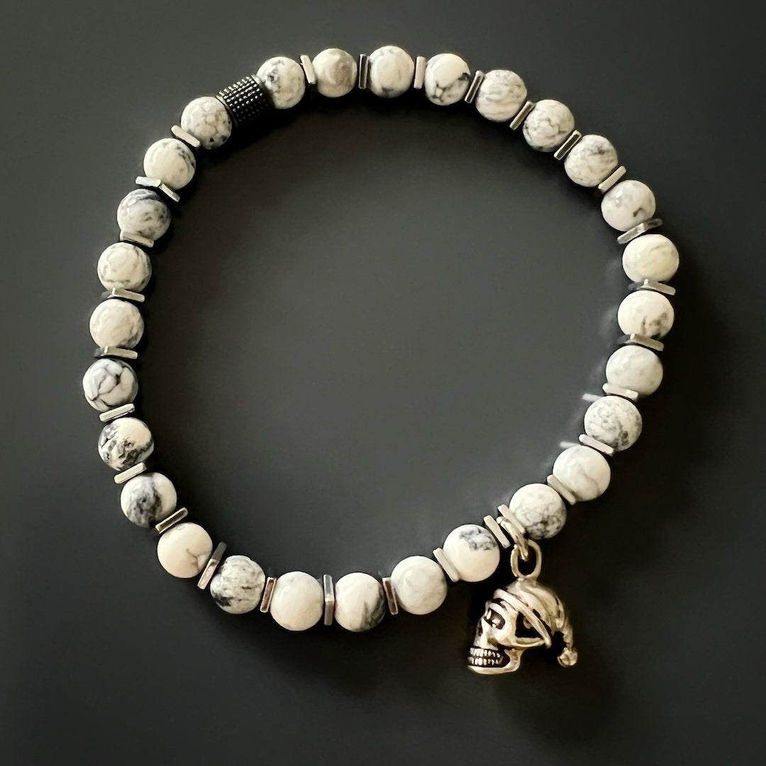 Adorn your wrist with the Men&#39;s Spiritual Beaded Skull Bracelet, a unique accessory featuring White Howlite beads and a Sterling Silver skull charm.