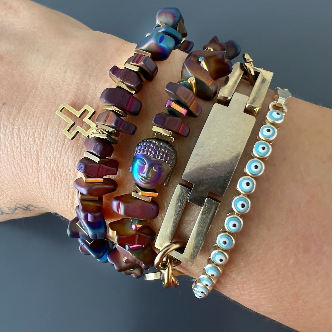 The model wears the Mystic Buddha Bracelet, showcasing its captivating design and spiritual essence, as the bracelet adorns her wrist with the serene Hematite Buddha bead, inspiring tranquility and inner peace.