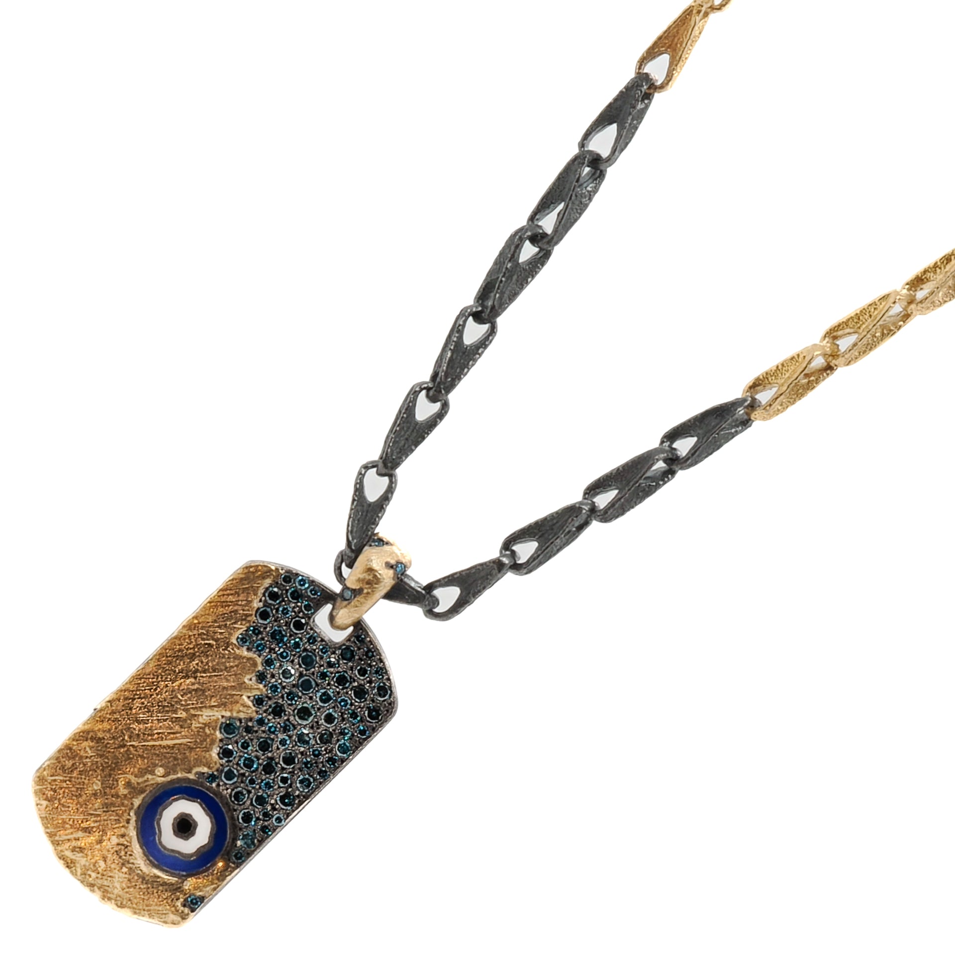 Detailed shot of the rough silver and gold surfaces of the Nature Dog Tag Evil Eye Necklace, highlighting the unique and imperfectly finished nature of the piece.