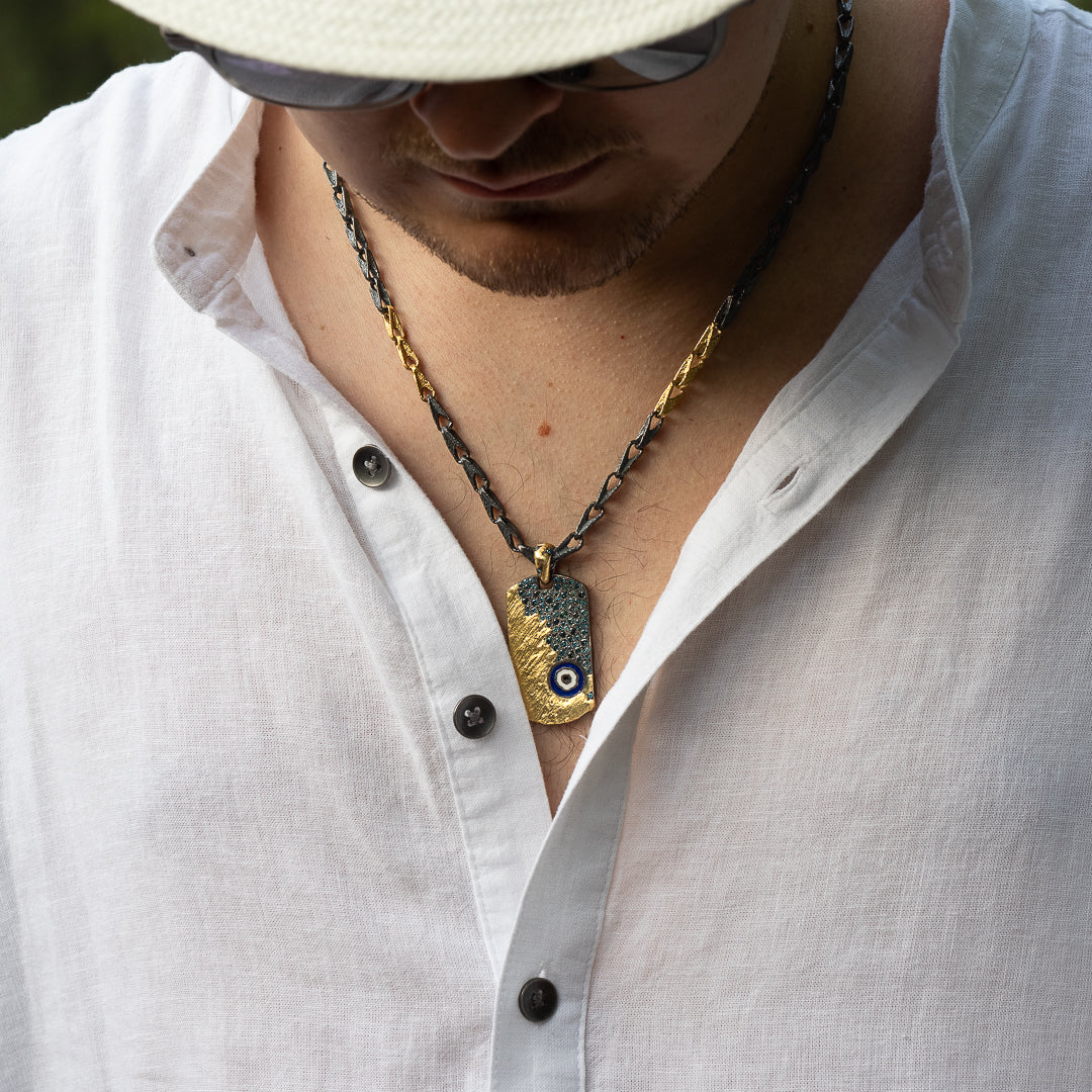 Model wearing the Nature Dog Tag Evil Eye Necklace, exuding confidence and style with this captivating accessory.