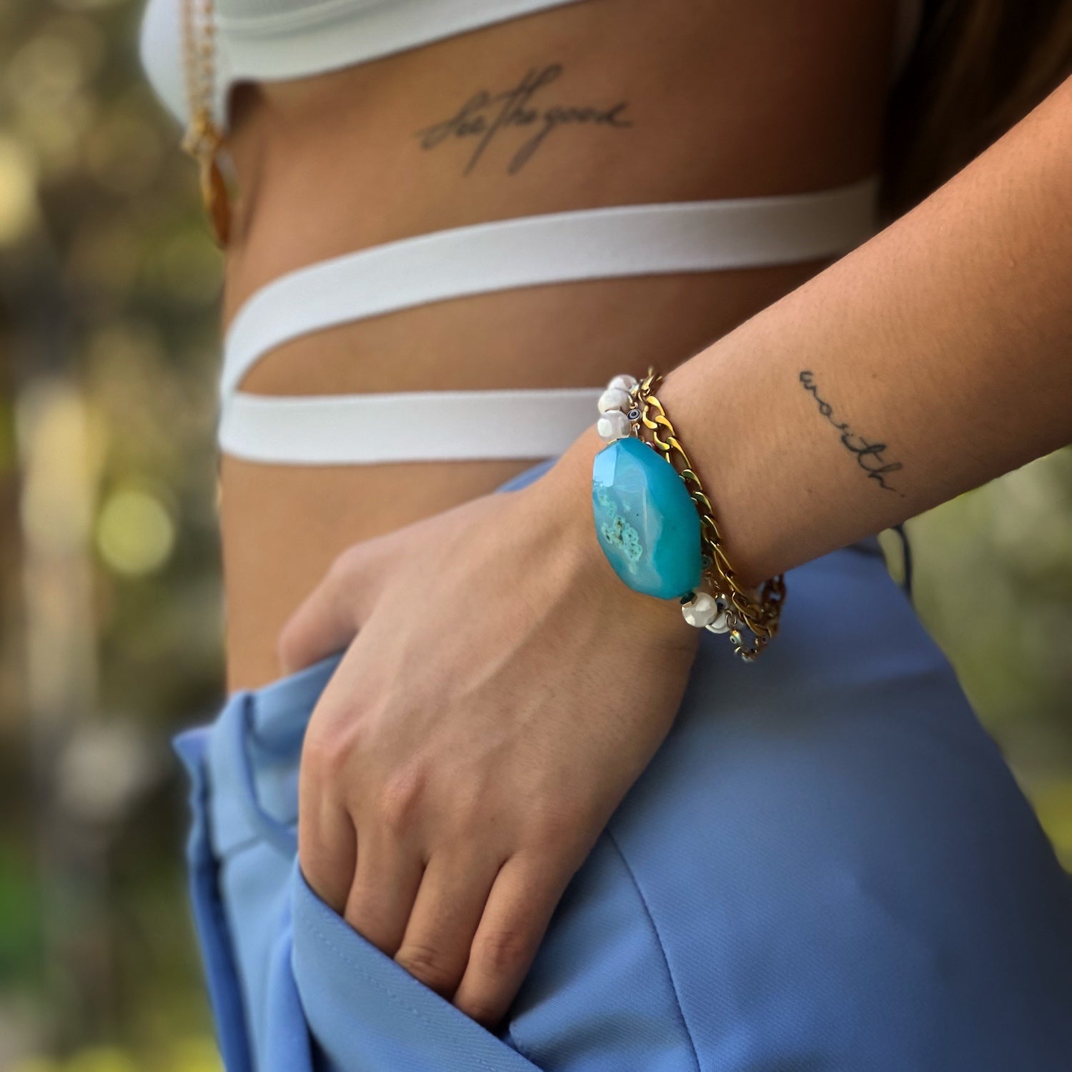 With the Nepal Blue Agate Bracelet adorning the hand model&#39;s wrist, its unique design and craftsmanship are on full display.