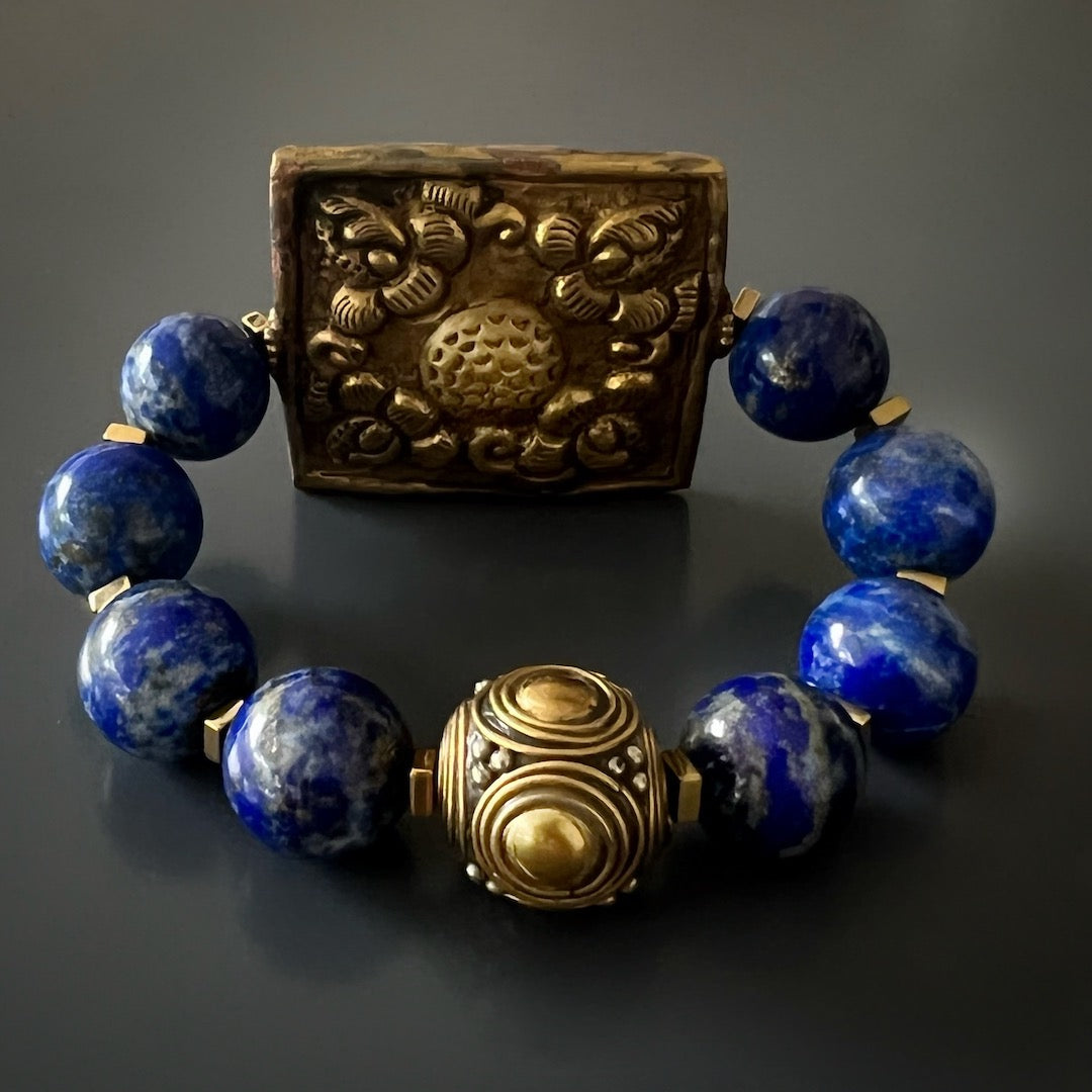 Discover the essence of Nepal with the Nepal Energy Bracelet, showcasing lapis lazuli beads and a handcrafted brass piece.
