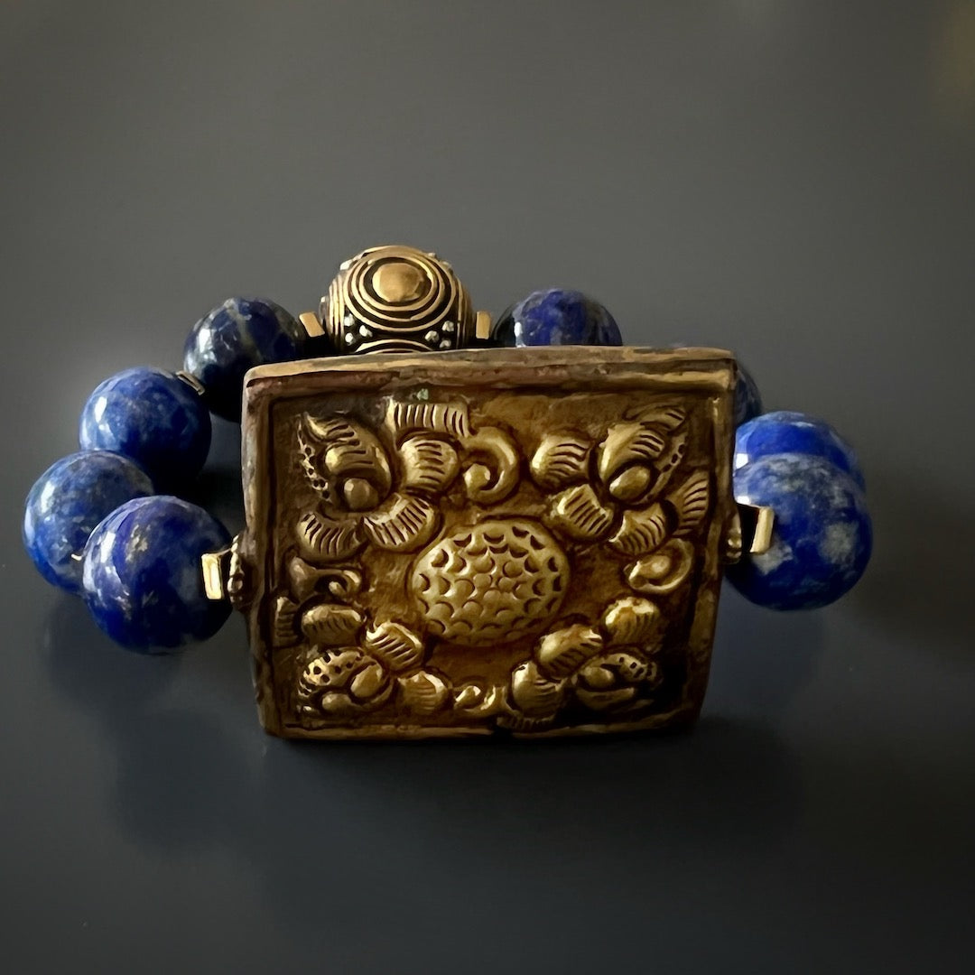 Find serenity and beauty with the Nepal Energy Bracelet, adorned with lapis lazuli beads and a Nepalese brass centerpiece.
