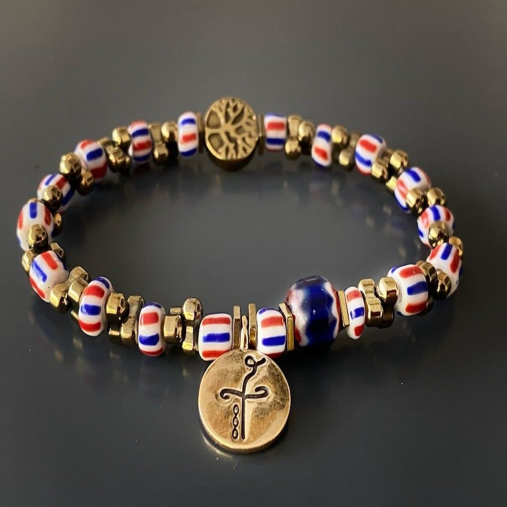 Celebrate the healing power of nature with the Nepal Heal Bracelet, a captivating accessory with a tree of life bead and colorful African beads.