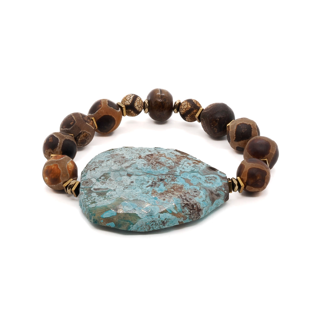 Discover the beauty of the Ocean Whisper Bracelet, featuring Tibetan Agate beads and a large sky blue ocean jasper stone.