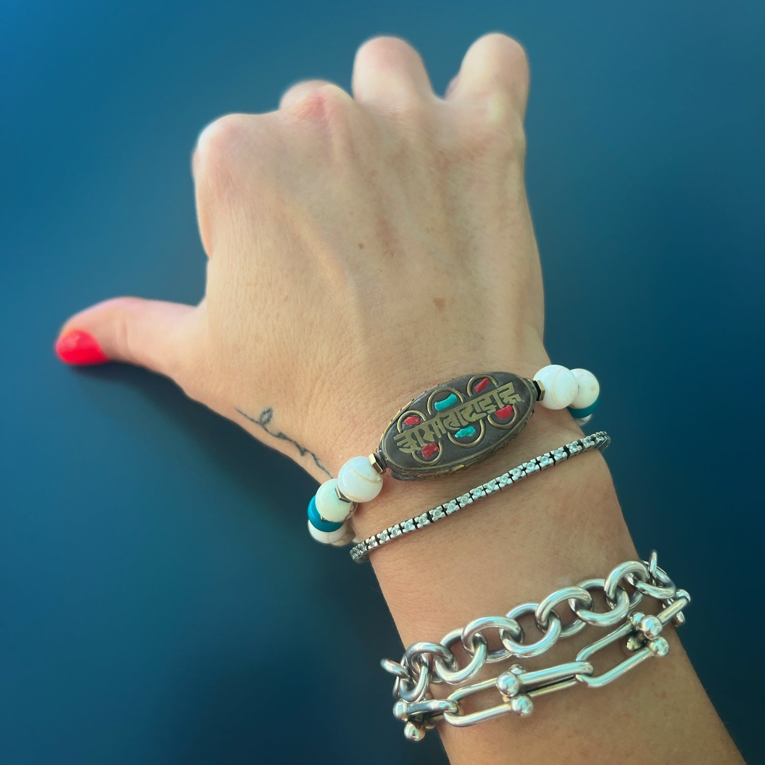 With the Om Mani Padme Hum Nepal Bracelet on her wrist, the hand model radiates a sense of inner peace and wisdom.