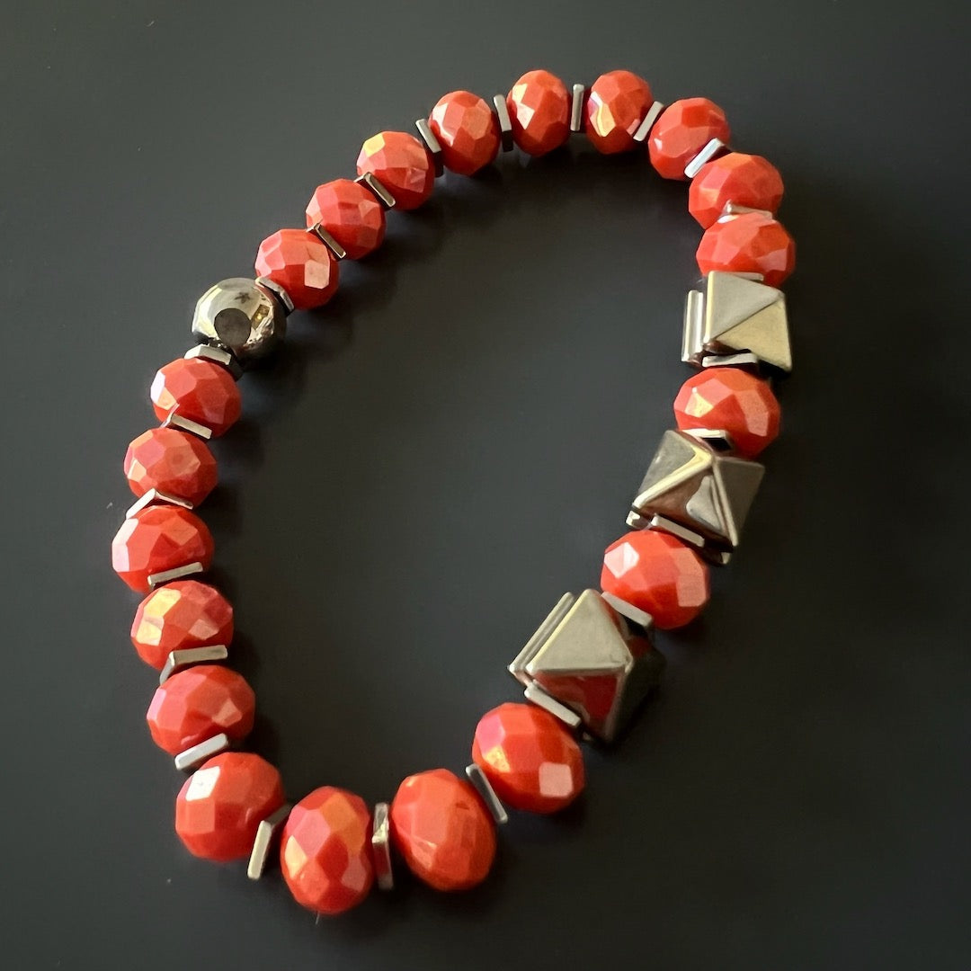Experience the uplifting energy of the Orange Energy Bracelet, adorned with orange crystal beads and accented by silver hematite stone beads.