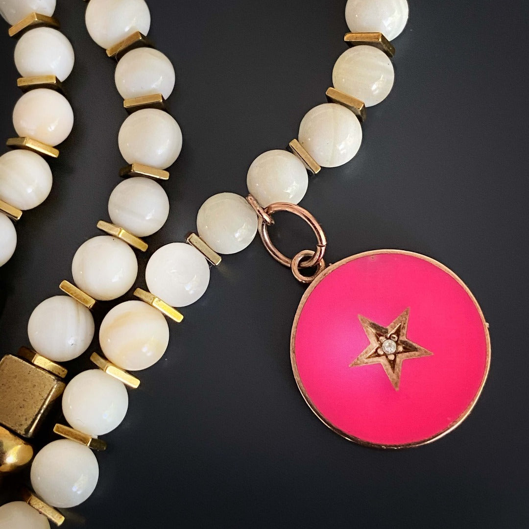 Radiate grace and elegance with the Pink Star White Choker Necklace, a unique accessory crafted with tridacna stones and gold hematite spacers.