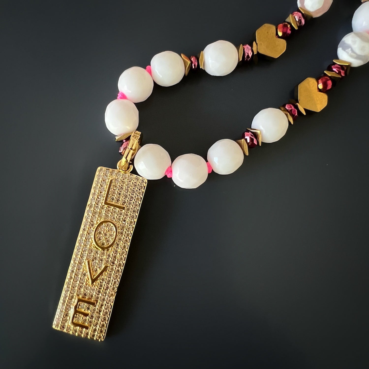 Power Of Love Necklace featuring a combination of Jade beads, gold-plated LOVE pendant, and turquoise stone beads, radiating a sense of serenity and positive energy.