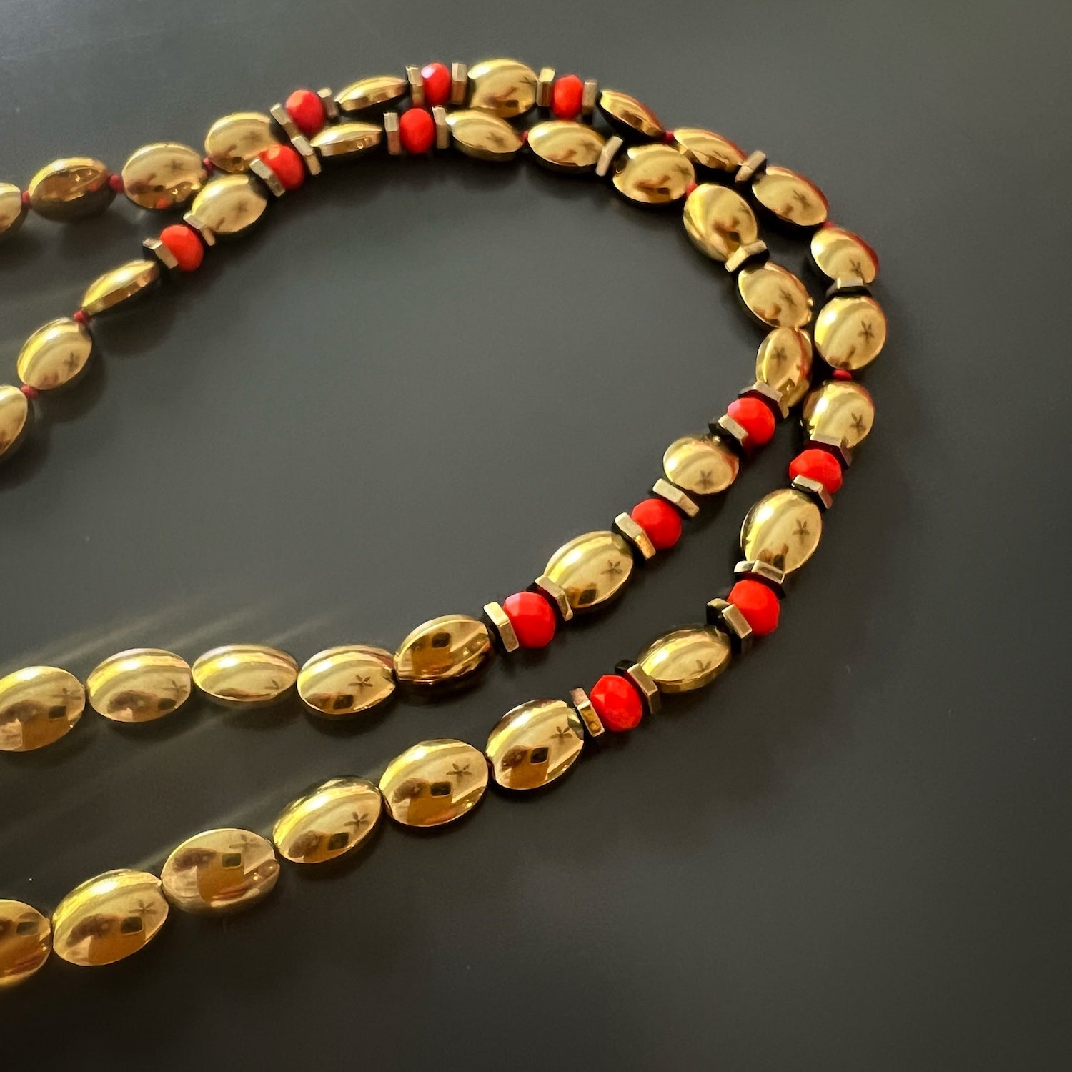 The golden hues of the hematite stone beads on the Powerful Protection Talisman Necklace