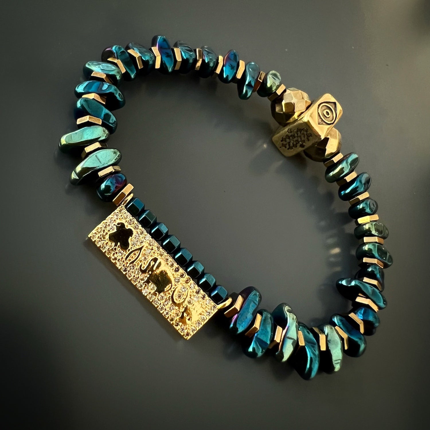 Explore the symbolic significance of the Protection & Luck Blue Hematite Bracelet, adorned with talismanic symbols and blue hematite stones.
