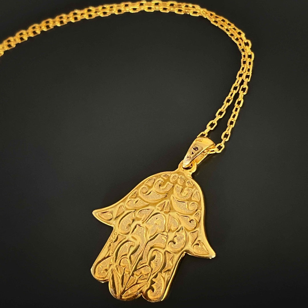 Experience the elegance and spiritual significance of the Pure Love Hamsa Necklace, with its white enamel Hamsa pendant on an 18K gold plated chain, radiating pure love and protection.