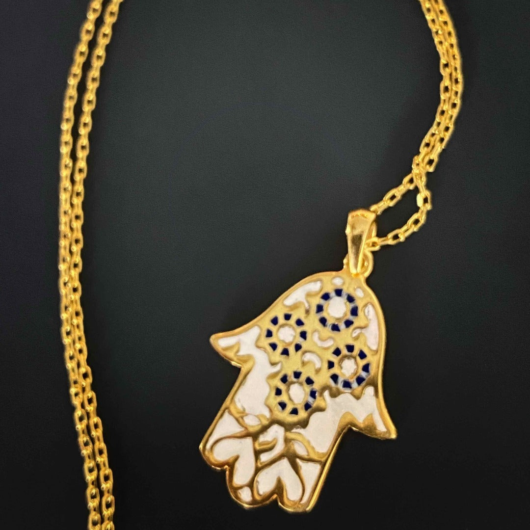 Embrace the power of pure love with the Pure Love Hamsa Necklace, featuring a stunning white enamel Hamsa pendant on an 18K gold plated chain.