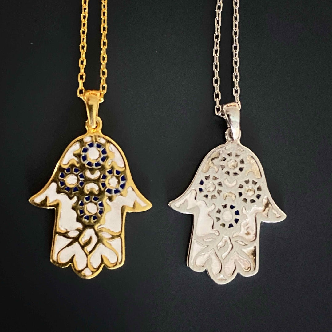 The Pure Love Hamsa Necklace is a blend of spirituality and elegance, featuring a white enamel Hamsa pendant on a sterling silver chain, reminding you to focus on pure love.