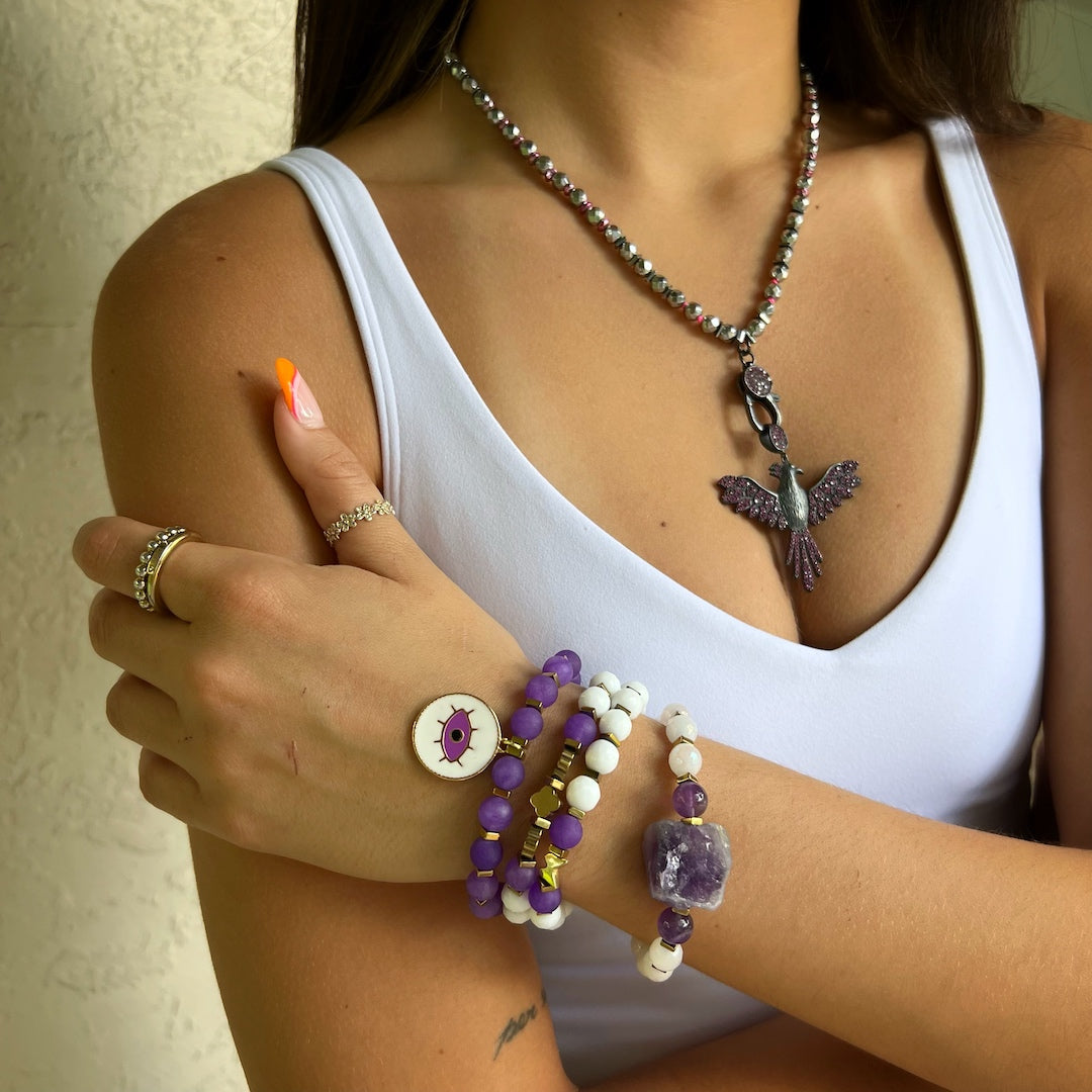 See the Purple Romantic Bracelet Set on the hand model's wrist, adding a touch of elegance and style to her overall look.