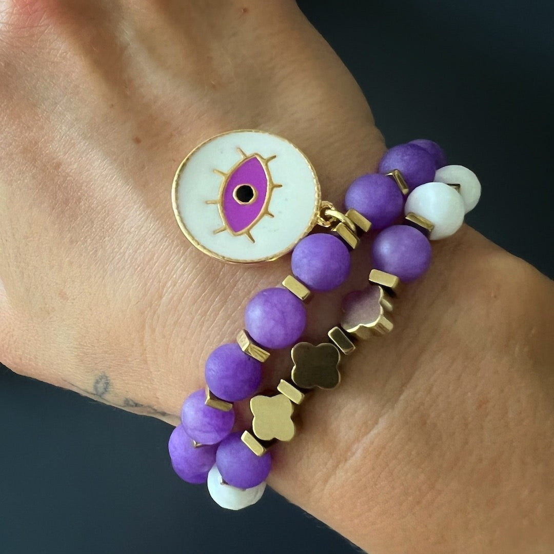 The hand model wears the Purple Romantic Bracelet Set, showcasing its beauty and meaning.
