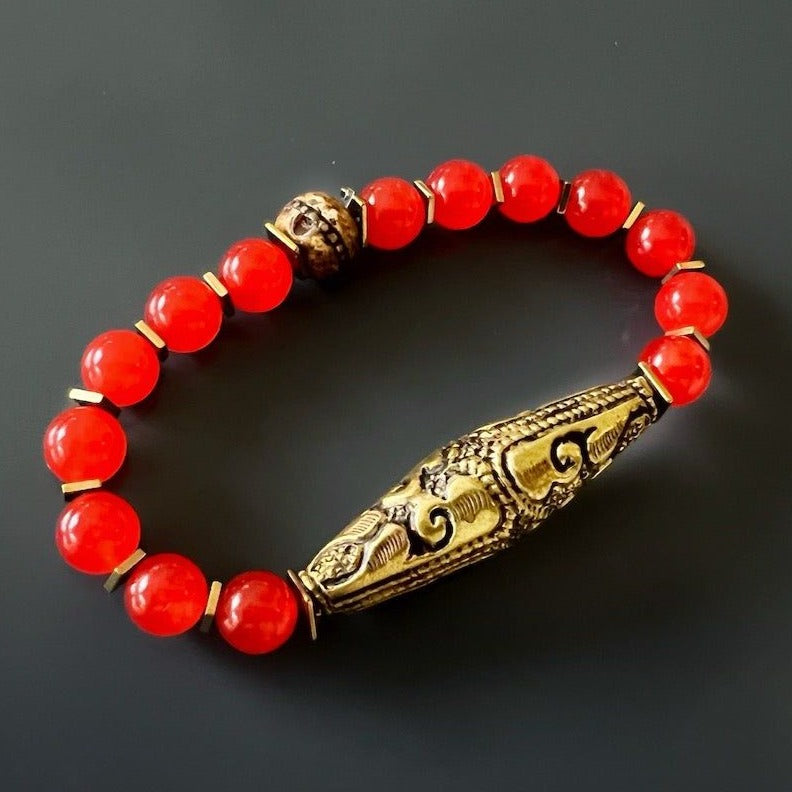 Discover the beauty and energy of the Red Carnelian Vintage Bracelet, featuring vibrant carnelian stone beads and a Nepal handmade brass charm.