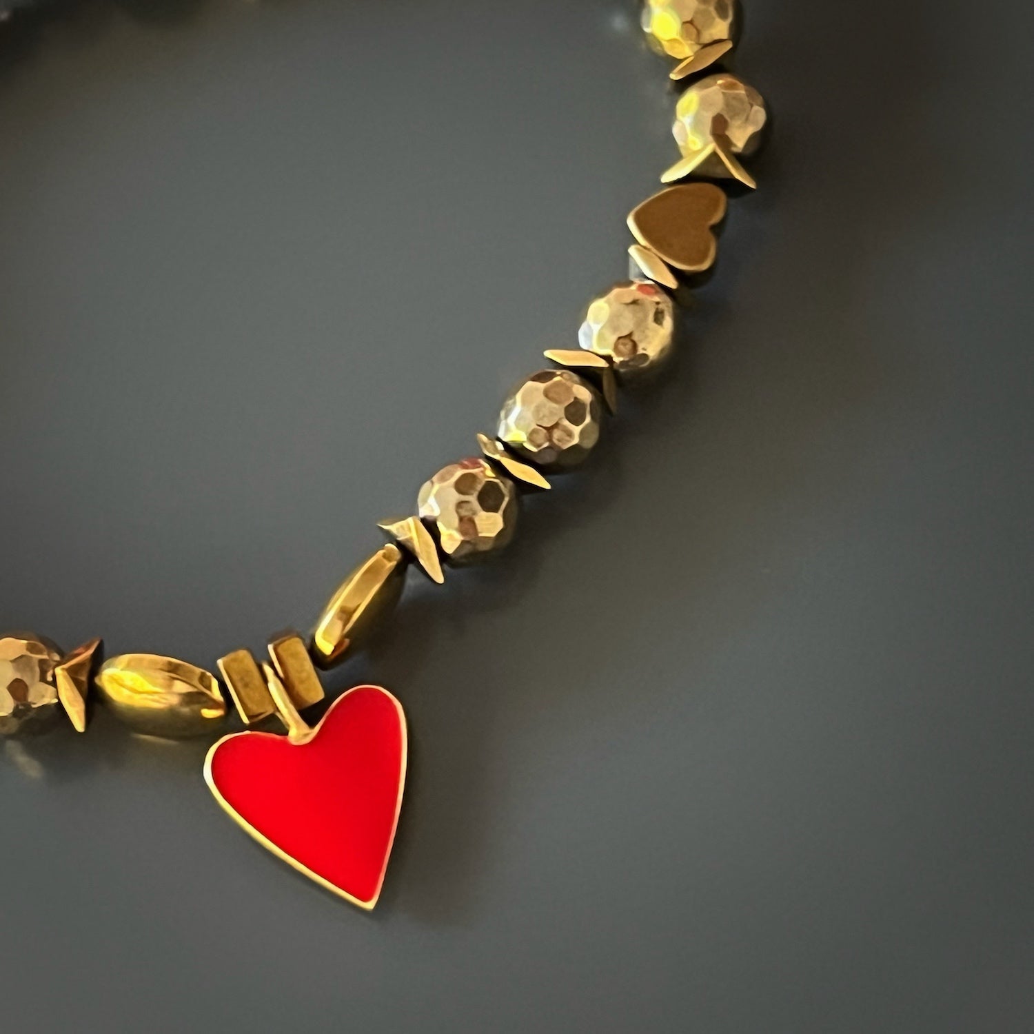 The Red Heart Love Bracelet combines elegance and love, with its gold-colored hematite beads and captivating heart charm.