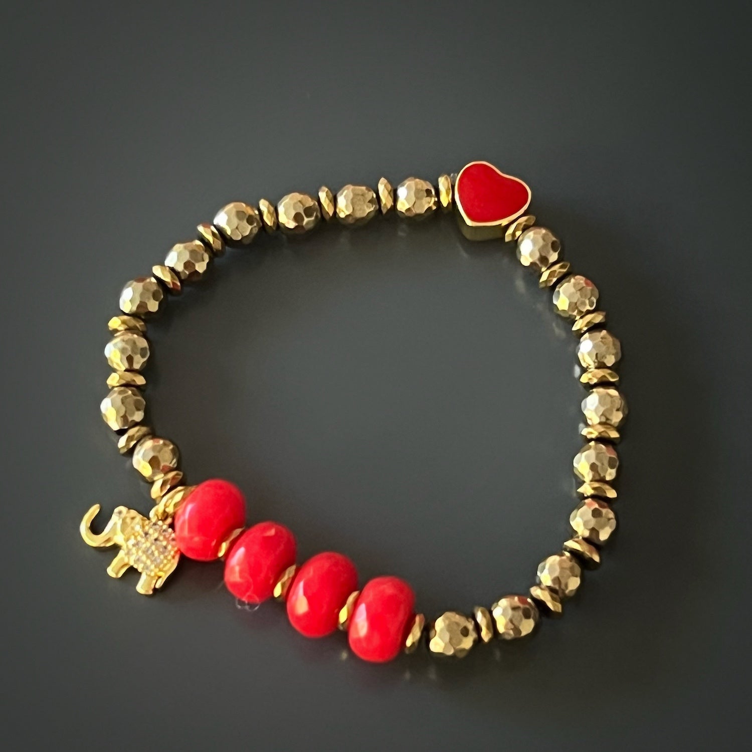 Carnelian beaded 2024 bracelet with coral chunk, and a Tibetan amber, coral, and bronze accent bead, with a bronze elephant charm